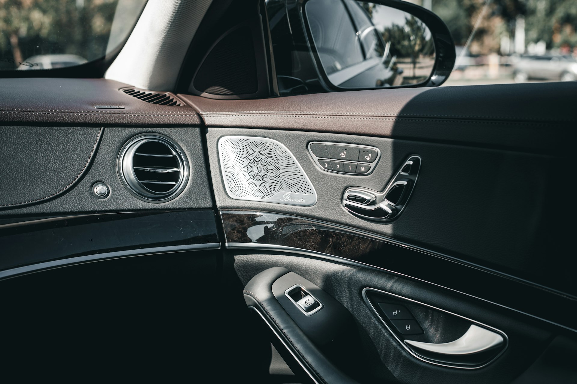 Luxury car door panel with leather and wood trim